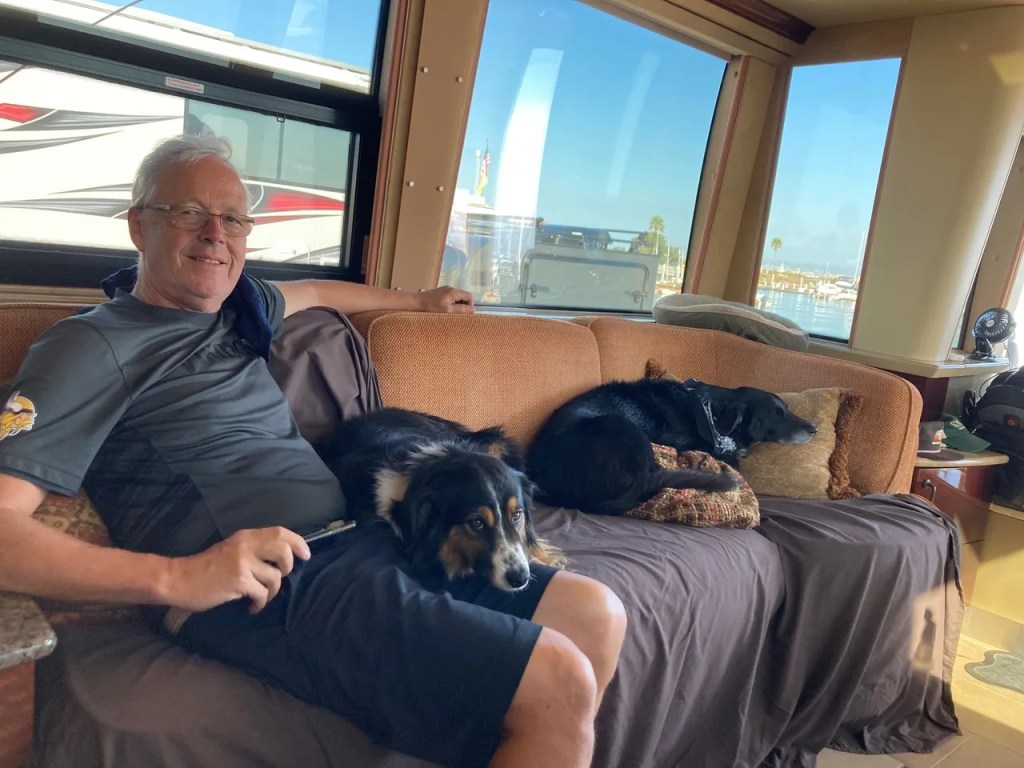 Jay relaxing with dogs on couch